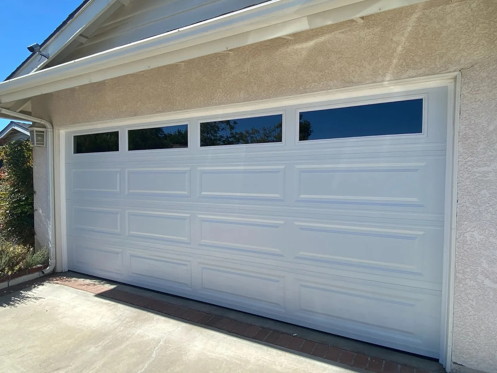 White long raised panel garage door with no window inserts